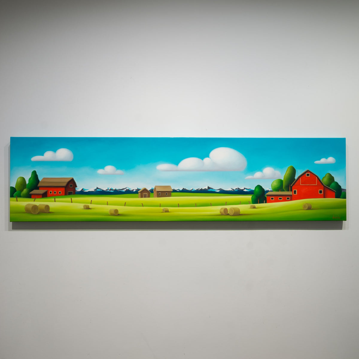 Red Barns: Cowboy Clouds by Dana Irving, 18 × 72 inch oil on canvas with red barns, hay bales and distant mountains.
