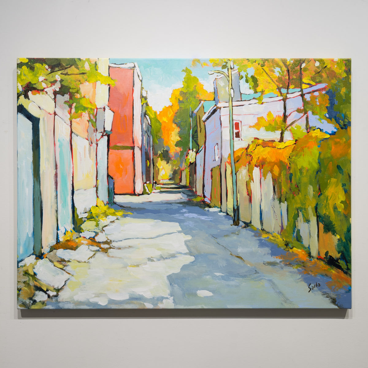 Ruelle Clôture Végétale by Sacha Barrette, 30 × 40 inch acrylic on canvas showing an alley with pale fencing, buildings and dense yellow-green foliage.