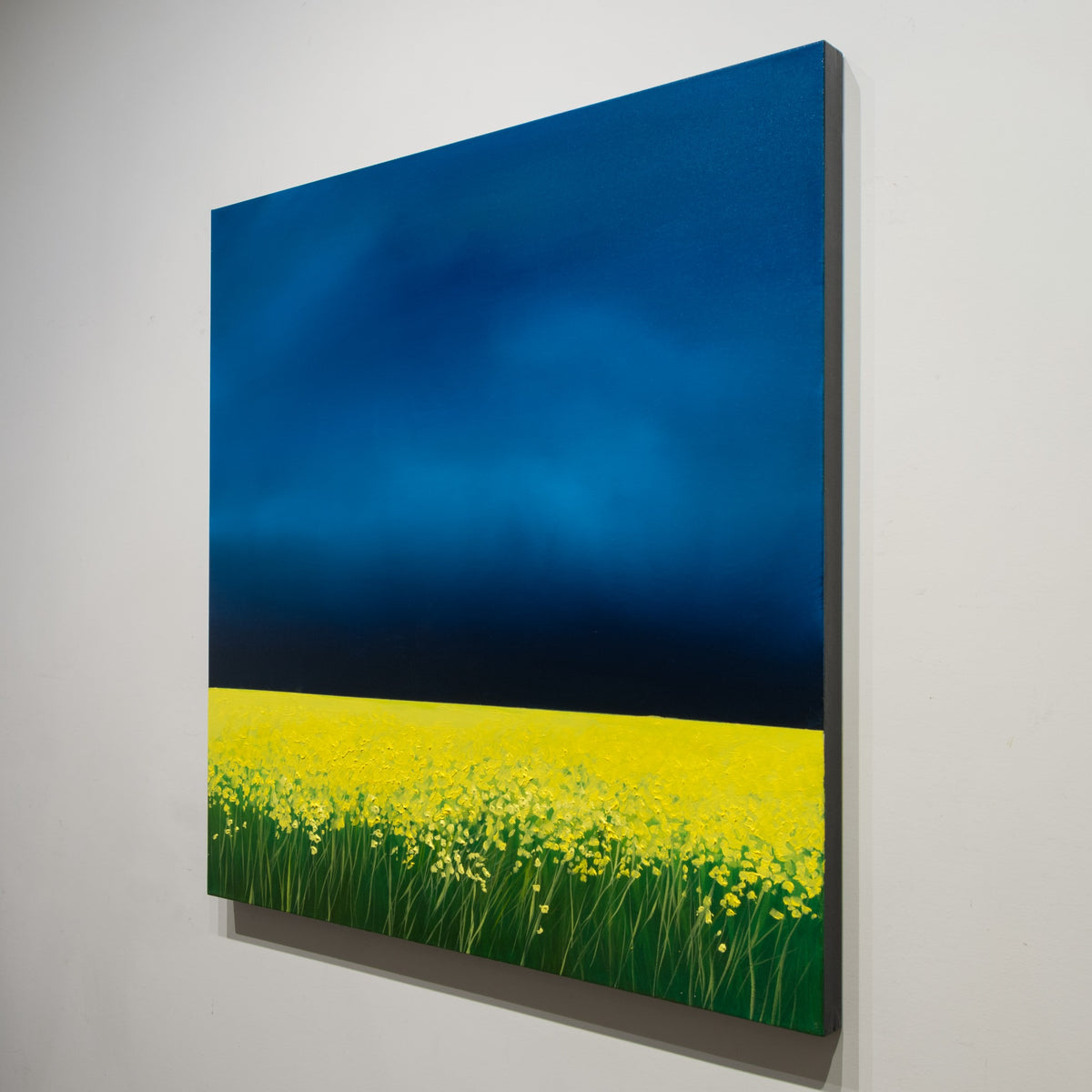 Angled view of Richard Cole's The Bright Edge showing the square painting and its unframed, finished black side.