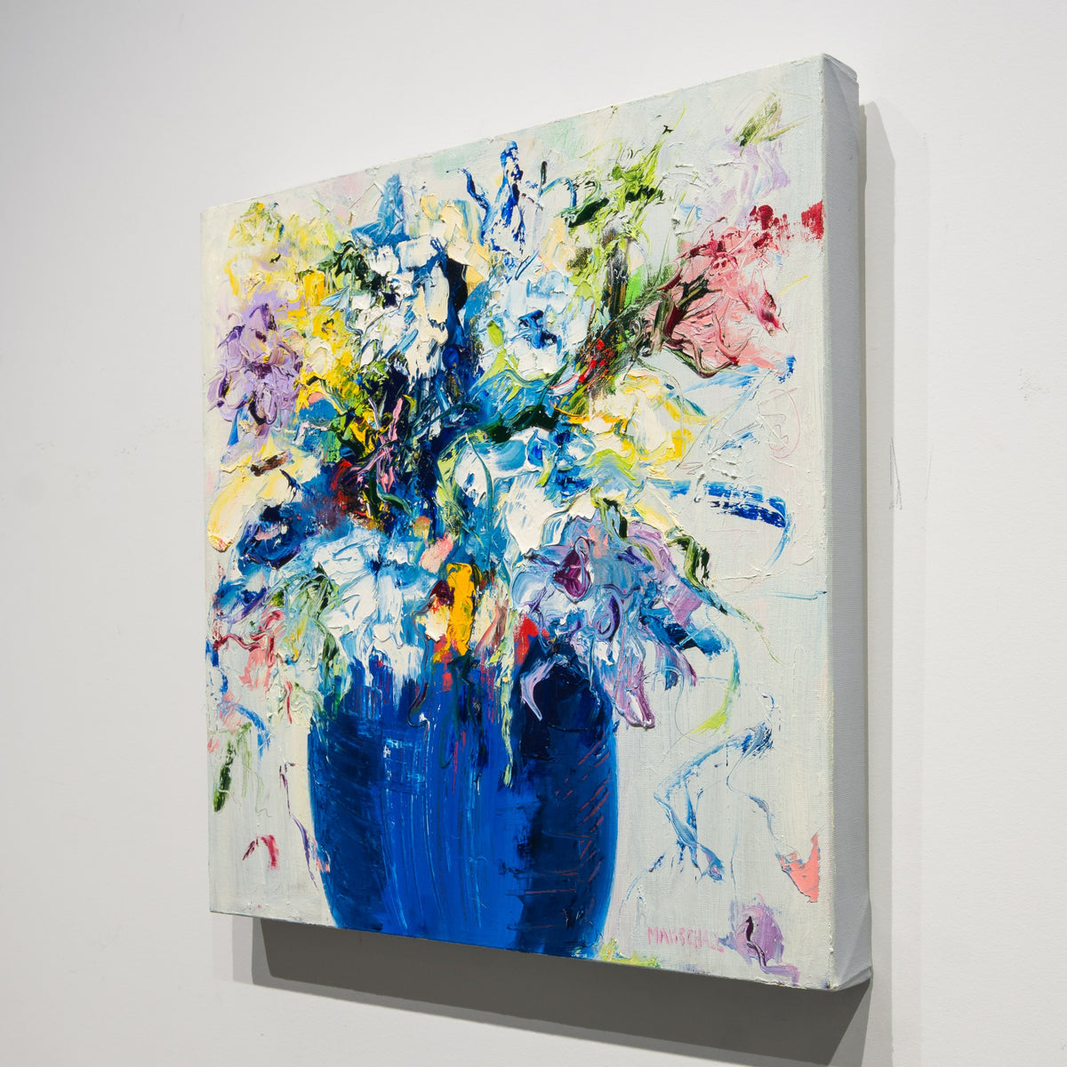 Angled view of Gerda Marschall's Love is in the Air showing the textured floral painting on an unframed canvas with a finished white side.
