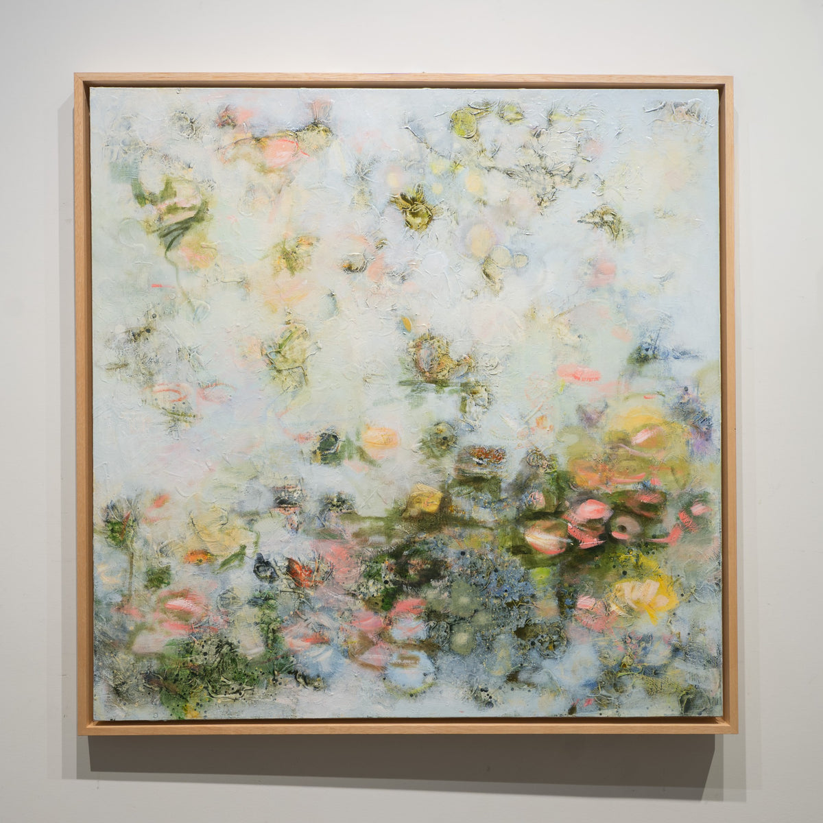 Le Chant de l etang by Ilinca Ghibu, 40 × 40 inch acrylic on canvas with a pale blue-grey ground and clustered pink, green and yellow floral forms.