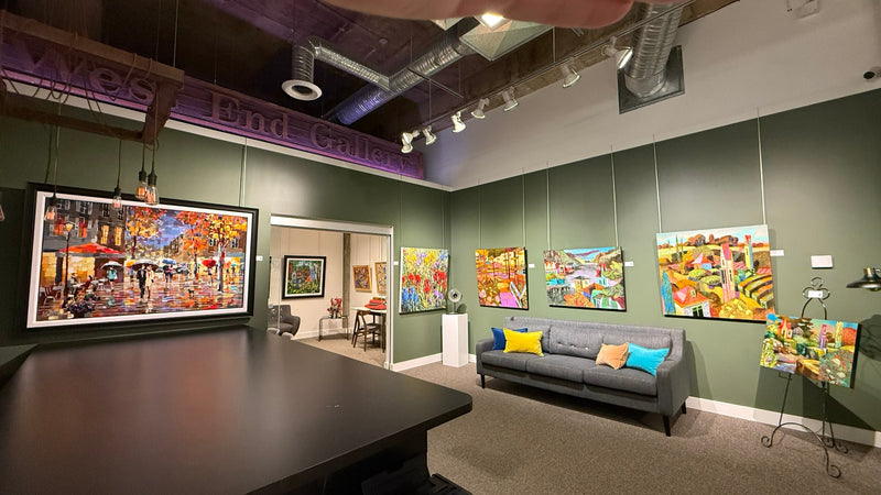 Modern office interior with colorful abstract paintings on green walls.