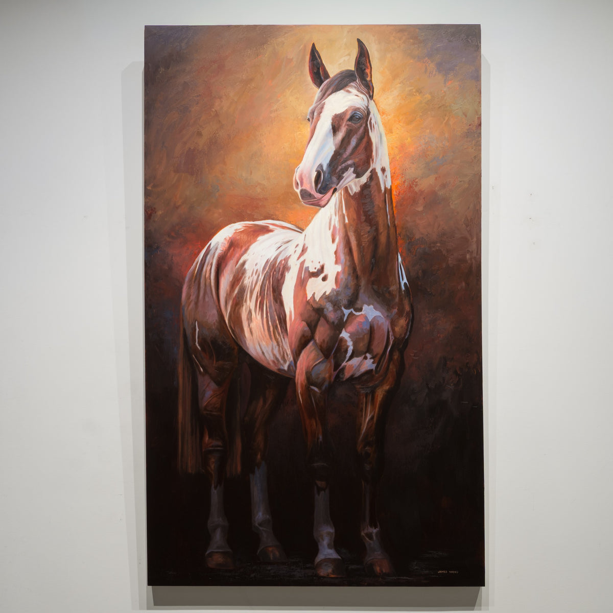 Glamorous Paint by James Wiens, 60 × 36 inch oil on board showing a brown-and-white horse against a warm amber and deep brown background.