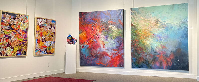 Art gallery with abstract paintings on a white wall