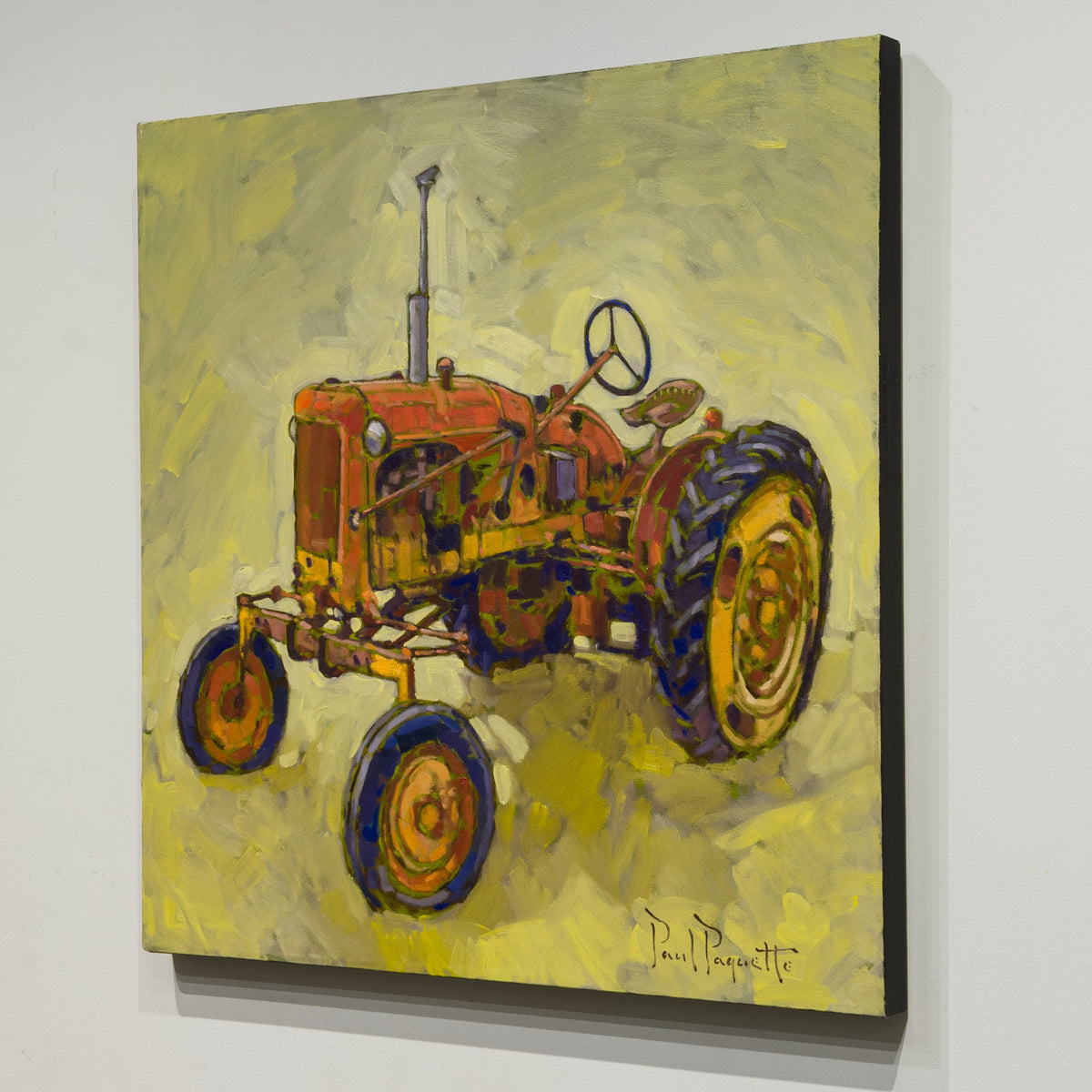 Angled view of Paul Paquette’s The Old Red Tractor showing the unframed canvas and finished black edge.